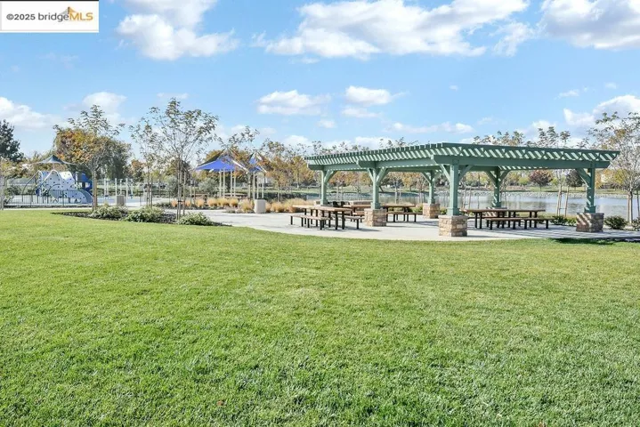 View of property's community featuring a patio area and a yard