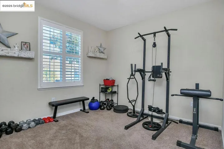 Workout area featuring baseboards and carpet