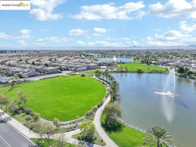 Aerial perspective of suburban area with a water and mountain view