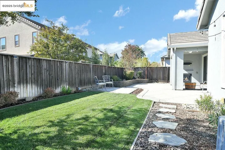 Fenced backyard with a patio area