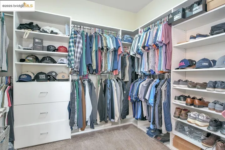 Walk in closet featuring light carpet