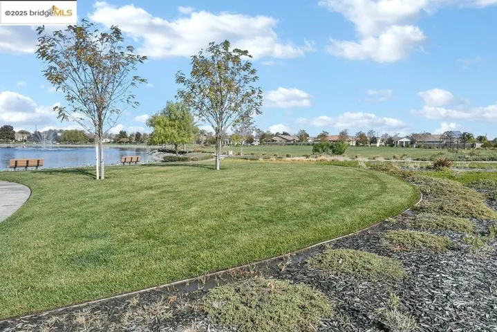 View of green lawn featuring a water view