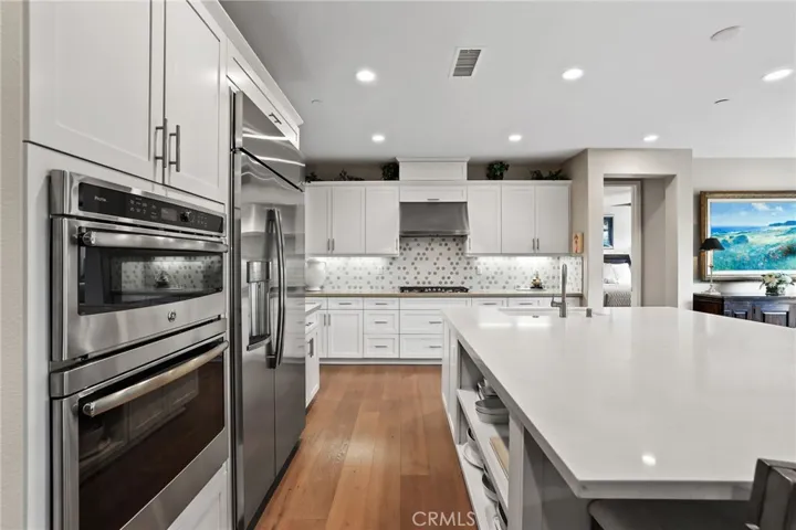 Contemporary kitchen with built-in ovens and panoramic views through the window.