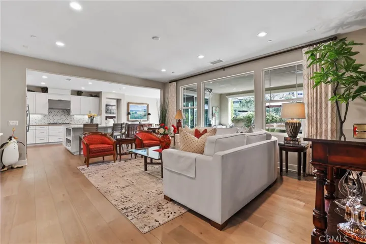Open concept living room with natural light and access to the kitchen.