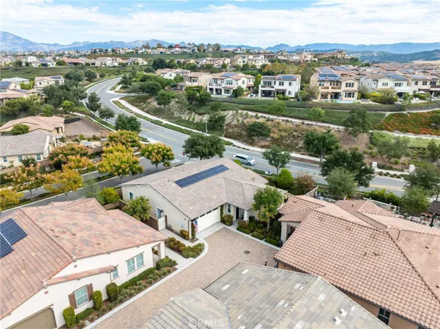 Elevated aerial shot capturing scenic surroundings and nearby homes.