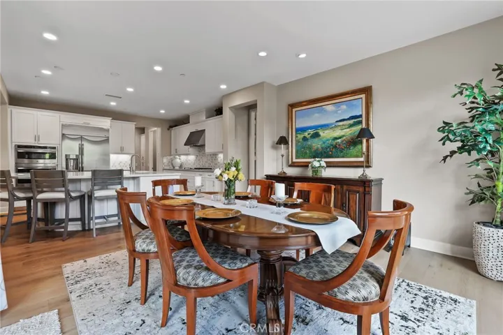Elegant dining room with wooden floors and stylish furnishings, perfect for family meals.