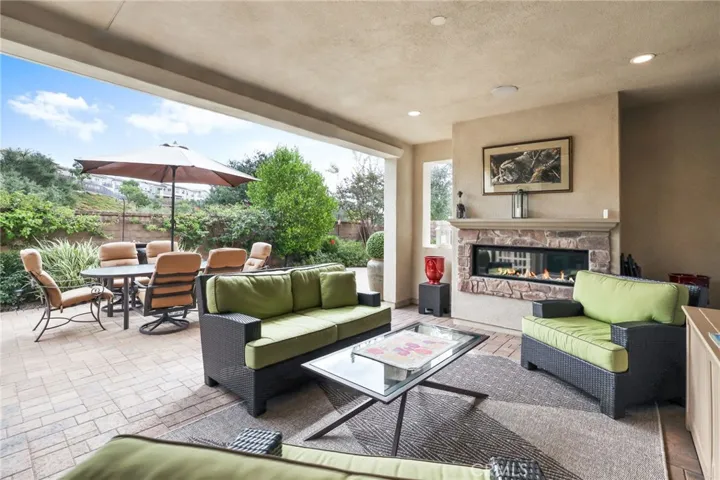 Outdoor lounge area with comfortable seating and scenic garden views.