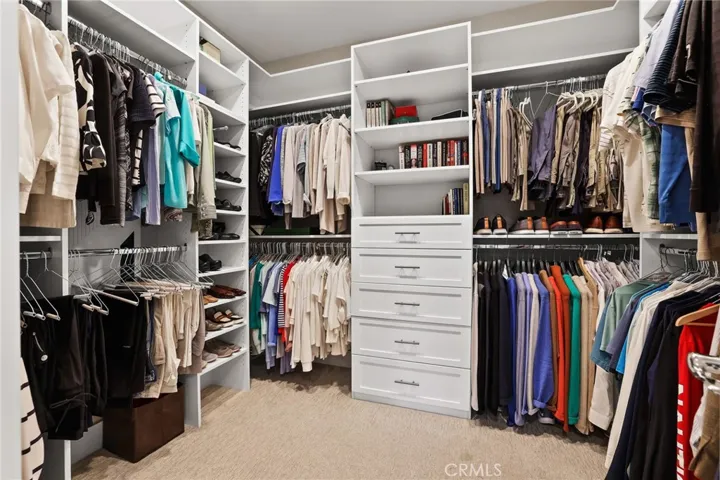 Spacious walk-in closet with custom shelving and organized storage solutions.