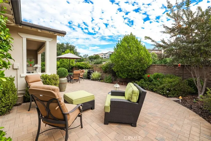 Intimate outdoor seating area surrounded by greenery for privacy.