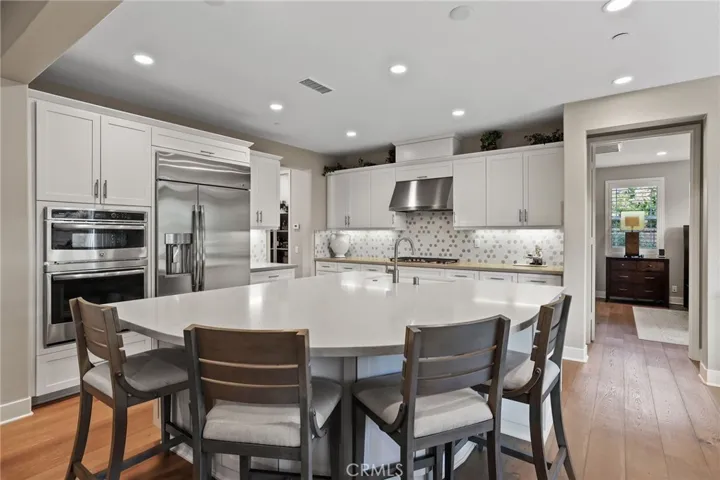 Cozy dining area adjacent to the kitchen with elegant lighting and neutral tones.