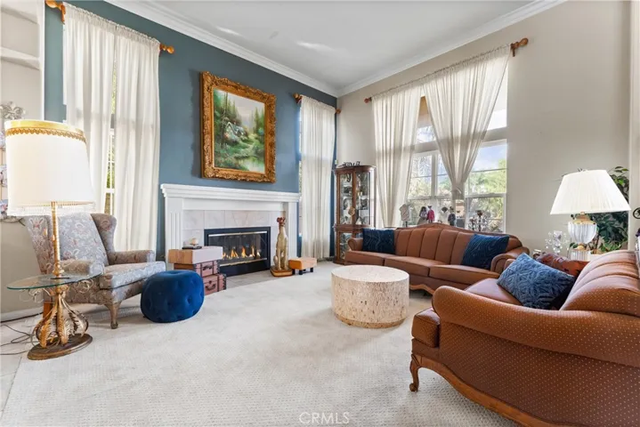 Floor to ceiling windows provide great light and views while the fireplace provides a great focal point in the room!