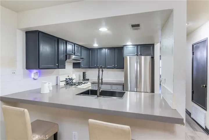 Beautiful breakfast bar with nice counter tops, stainless steal refrigerator included.