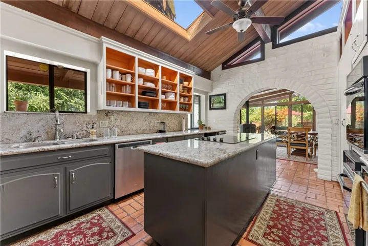 Main house kitchen passes through to the breakfast room overlooking the pool.