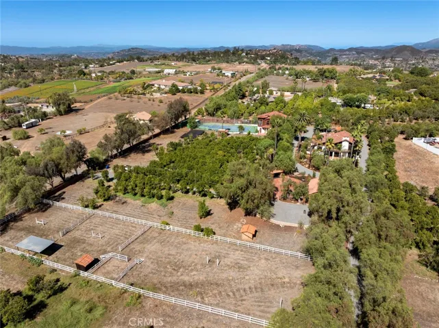 The corrals are located at the front of the property surrounded by the grove.  There is plenty of room to add an arena and another barn if desired.