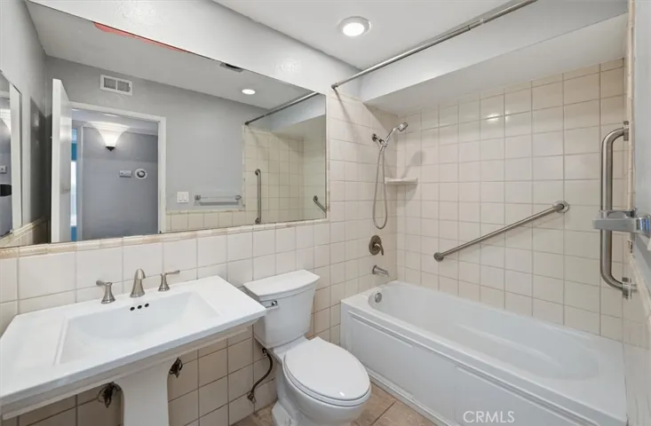 Hallway bathroom with grab bars