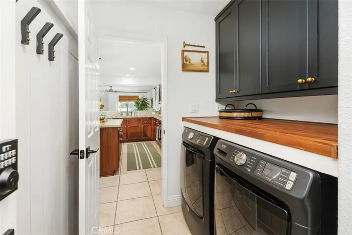 Laundry Room with wall paneling, new upper cabinets and butcher block counter.