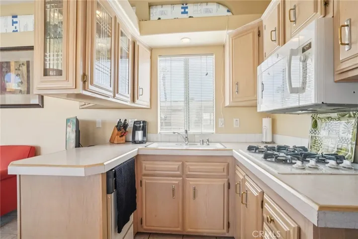 Well cared for kitchen with range top, dishwasher, combo convection/micro oven, and lots of storage.