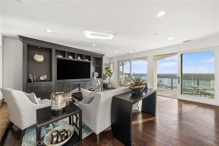 Great Room-Entertainment Center w/72" Smart TV/Plush Seating/Rich Hardwood Flooring/Wall of Glass Sliders View Southwest