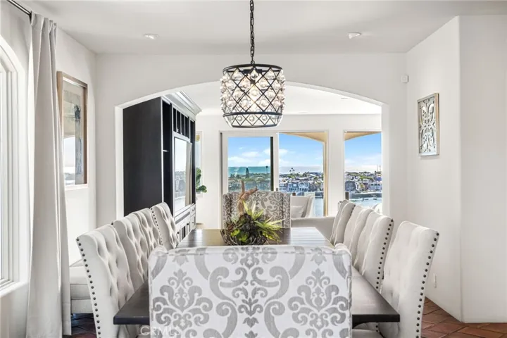 Formal Dining Room-Seats 10 Tufted High-Back Chairs/Exquisite Lighting-Crystal Chandelier/Kitchen Adjacent on right/Great Room ahead View West