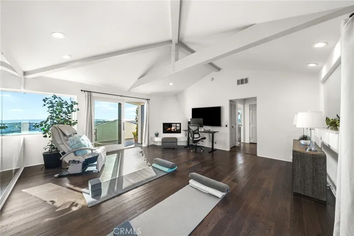 Yoga Studio (Convertible Room)-Vaulted Beamed Ceiling/Fireplace (see-through indoor/outdoor)/Massage Chair/Yoga Mats/Wall Mounted Smart TV/Mirrored Wall/Terrace Access View West