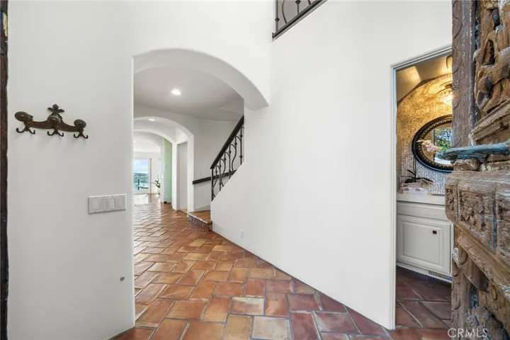 Foyer Entrance-From Italy 1,000 Year Old 8' Ornate Carved Double Wooden Front Doors/Powder Room on right/Stairway to Upper-3rd Level/Hallway View West