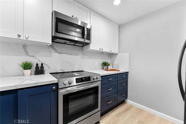 Gorgeous kitchen with soft closed cabinet features. Quartz counter has beautiful veining that is classic in design. New appliances. New sink and fixtures. All new for you.