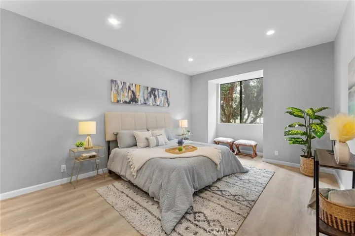 Spacious primary bedroom with high ceilings, newly installed luxury vinyl plank flooring, newly painted, recessed lighting.