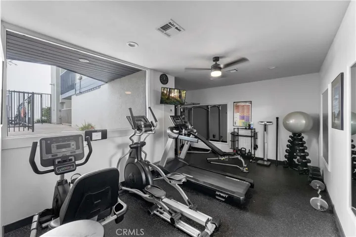 The gym has a view looking towards the pool.