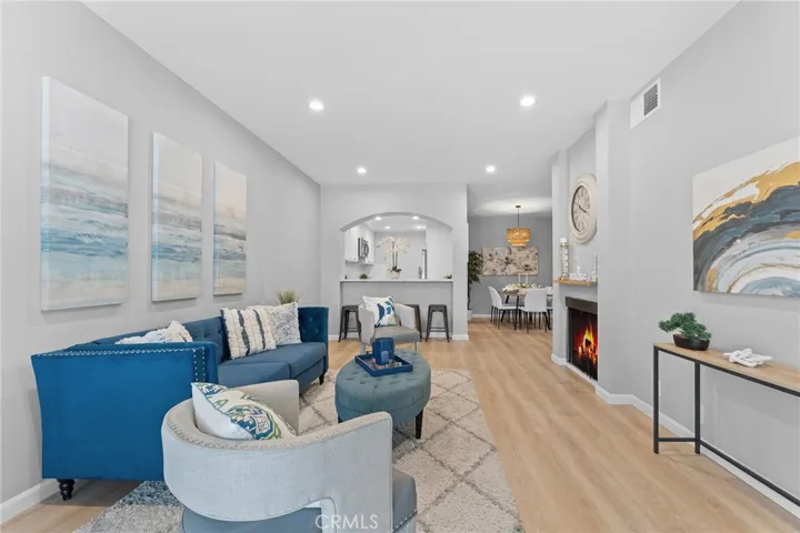 Beautifully updated, luxury vinyl plank flooring, recessed lighting,, newly painted. 9' ceilings. Room to dine casually at pass through to kitchen. Fire in fireplace is photoshopped.