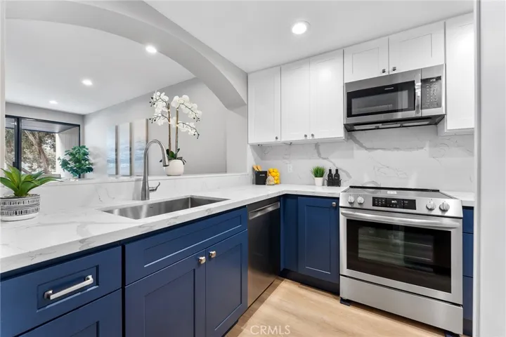 Gorgeous kitchen with soft closed cabinet features. Quartz counter has beautiful veining that is classic in design. New appliances. New sink and fixtures. All new for you.