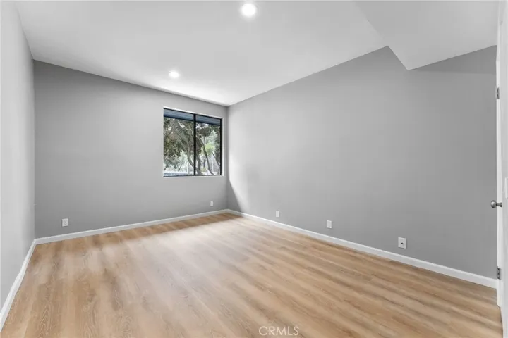 Spacious second bedroom with a walk in closet. Newly installed luxury vinyl plank flooring, newly painted, new recessed lighting.