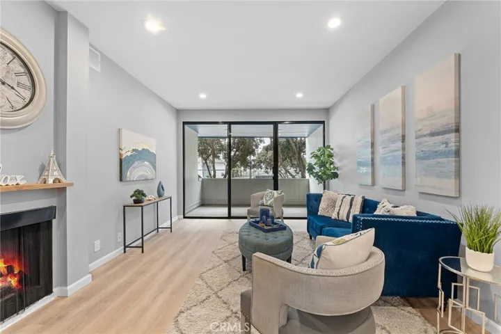 Fire in fireplace is photoshopped. Newly installed luxury vinyl plank flooring, recessed lighting, newly painted, 9' ceilings. Sliders to a patio that is roomy enough for a BBQ and seating.