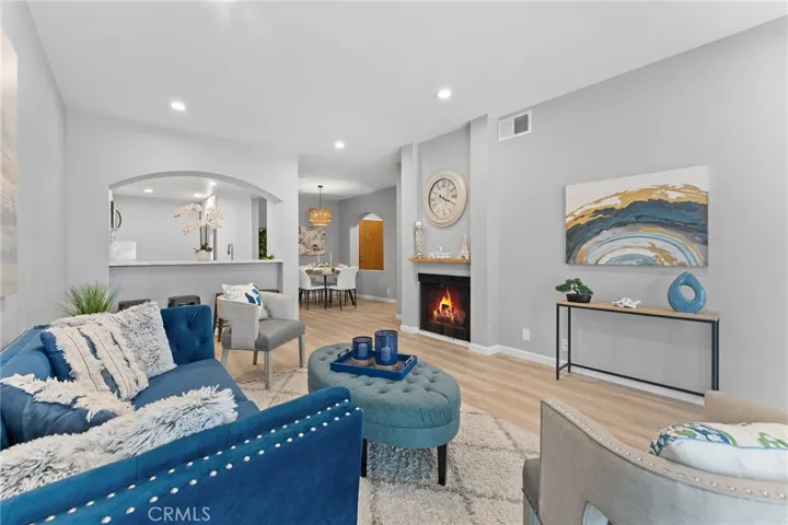 Beautifully updated, luxury vinyl plank flooring, recessed lighting,, newly painted. 9' ceilings. Room to dine casually at pass through to kitchen. Fire in fireplace is photoshopped.