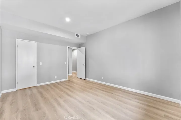 Spacious second bedroom with a walk in closet. Newly installed luxury vinyl plank flooring, newly painted, new recessed lighting.