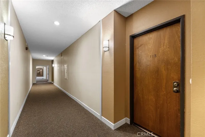 Down the hallway leads to the lobby and elevators to take you to the underground gated parking, and courtyard to the pool and gym, sauna and recreation room.
