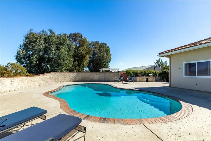 Generous outdoor entertaining space with seating and BBQ area.