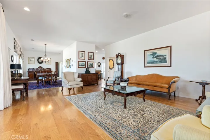 Grand living room with seamless flow to the formal dining room and kitchen.