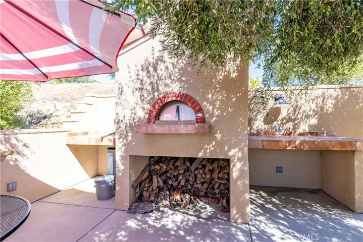 Custom-built pizza oven offers a fun and tasty outdoor activity.
