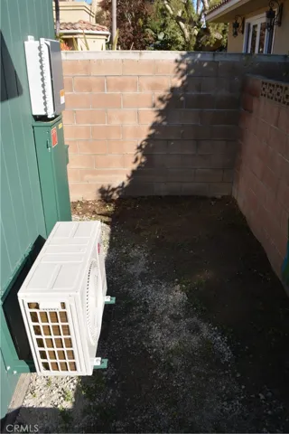 Left of front stoop.  Is a sunny coener that would be a good spot for a vegetable garden.