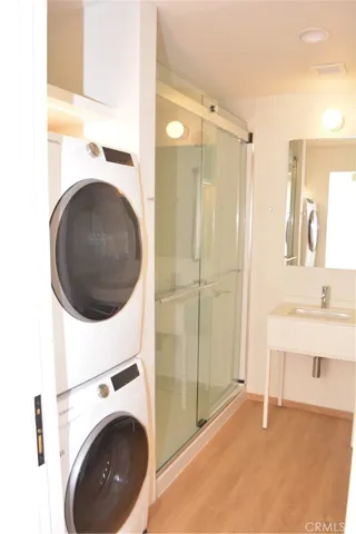 Stacked washer and dryer in the bathroom, just off hall.