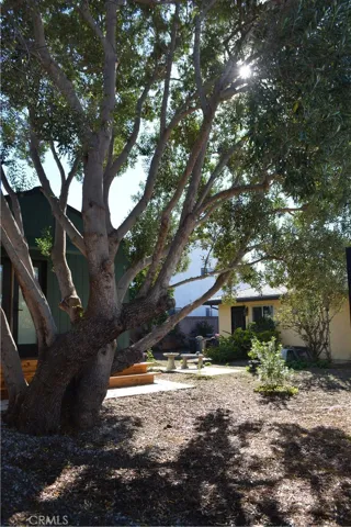 View of ADU and front house from entry gate.