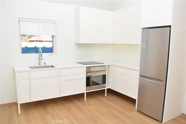 Kitchen features built-in appliances, two prep counter areas and ample cabinetry.