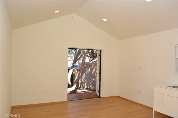 Great room has cathedral ceilings and recessed lights.
