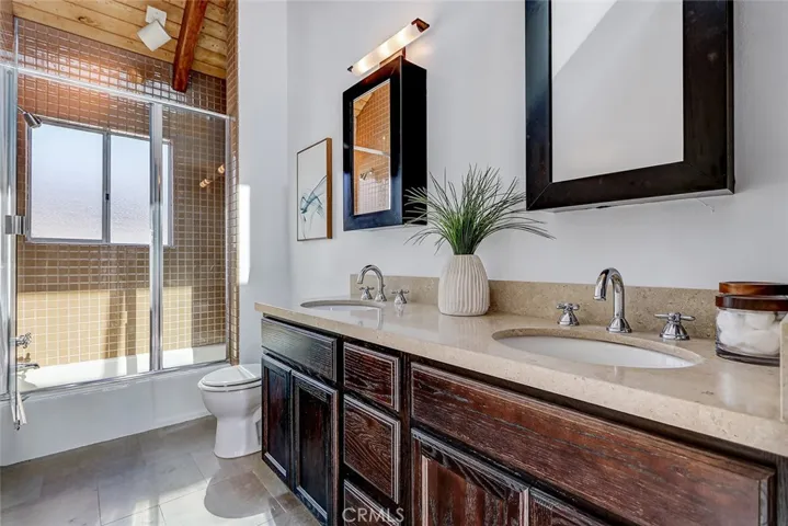 Full bath upstairs with double sinks, tub and shower.