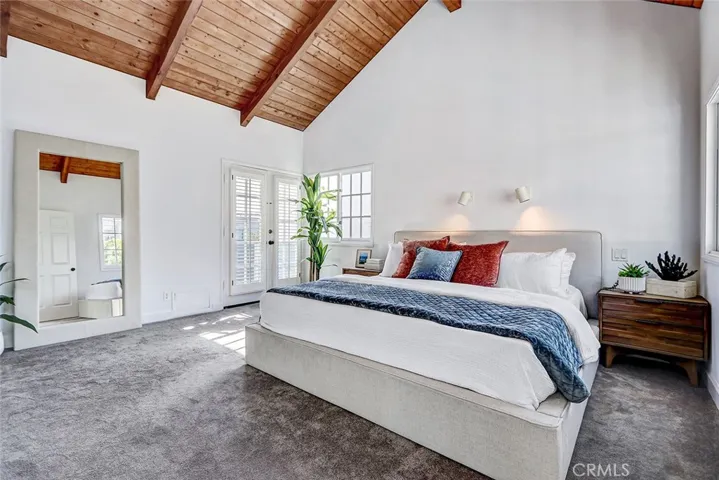 Primary bedroom with balcony.