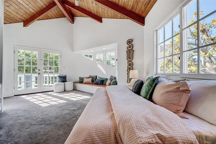2nd bedroom with high ceilings, balcony and plenty of natural light.