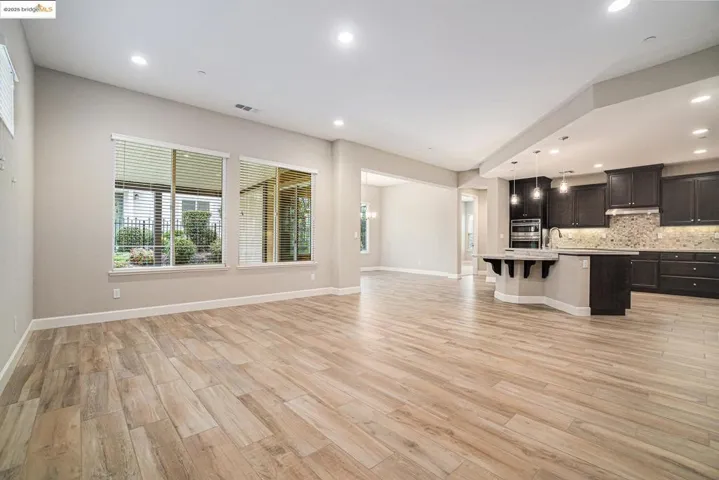 Unfurnished living room with light wood-style flooring and recessed lighting