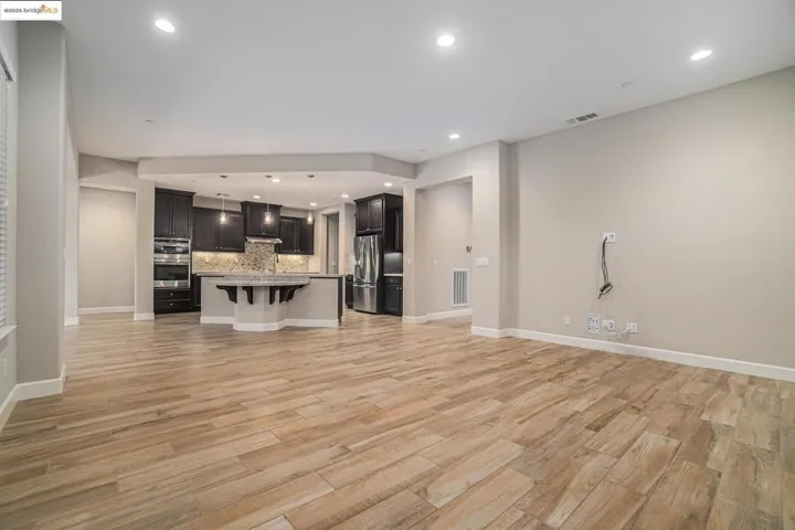 Unfurnished living room with recessed lighting and light wood-type flooring