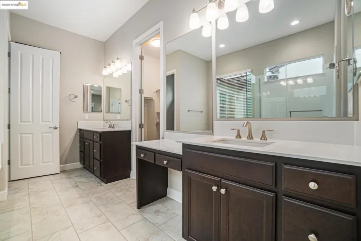 Bathroom with a stall shower and two vanities