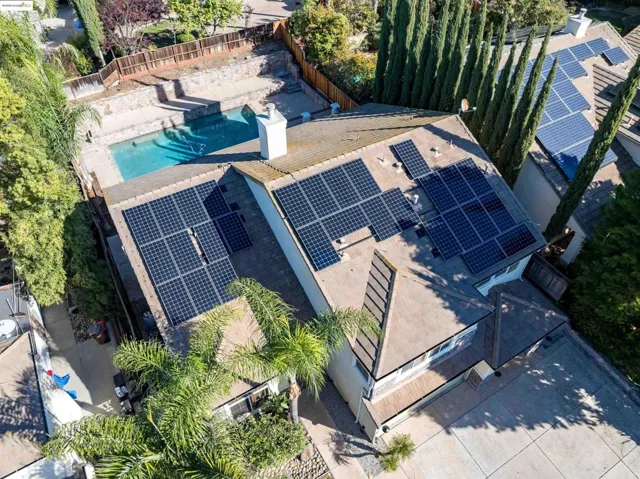 Aerial view of property and surrounding area featuring a pool area